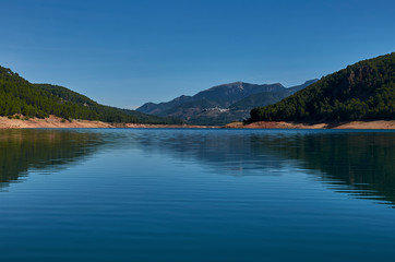 Fototapeta na wymiar Lake between mountains and forests