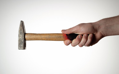 Hammer in mans haond on white background.