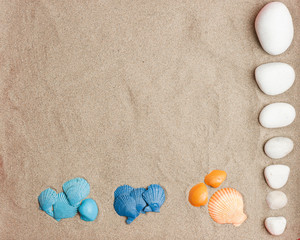 Fototapeta na wymiar sets of 3-color cochas, blue, light blue, orange and white stones on beach sand