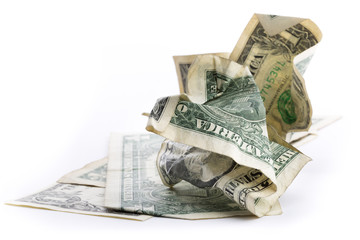 illustrating wasted savings opportunity, a crumpled US dollar bill on a pill of dollar bills...