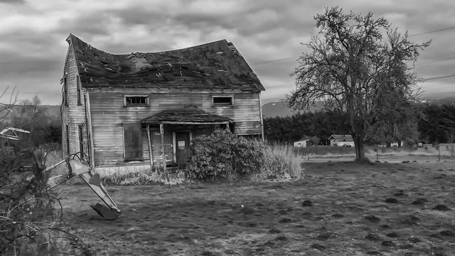 HD dolly shot approaching a spooky abandoned and decrepit farm house