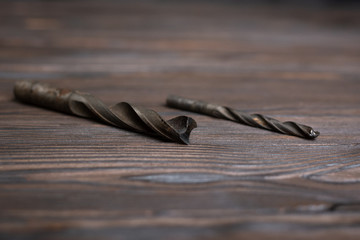 on a wooden table are two drills of different sizes. selective focus