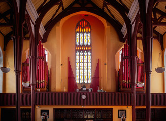 Red pipes of pipe organ in Holy Trinity Church