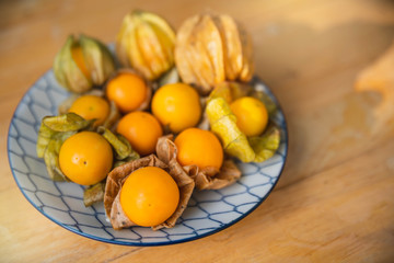Gape gooseberries and natural background. Cape gooseberry on wooden table. Cape Gooseberry from top view.  fresh cape gooseberry background , selective focus .