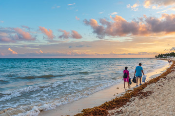 People walks on the caribbean shore in Riviera Maya