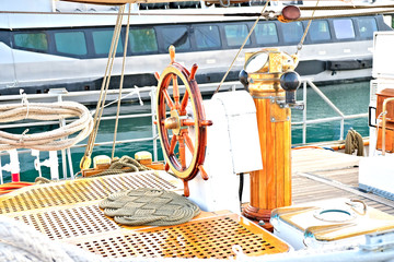 Steering wheel, helmsman station and steering compass on a classic sailing training vessel.