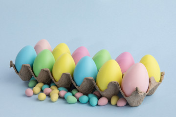 a dozen carton of colorful pastel Easter eggs isolated on white