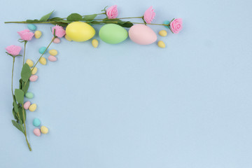 small and large Easter eggs as a border on a background with copy space