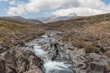 The Wairere Stream above the Taranaki Falls, with Mount Ruapehu in the background. Tongariro National Park, New Zealand.