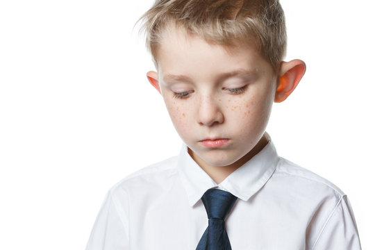 sad boy on isolated background schoolar in uniform