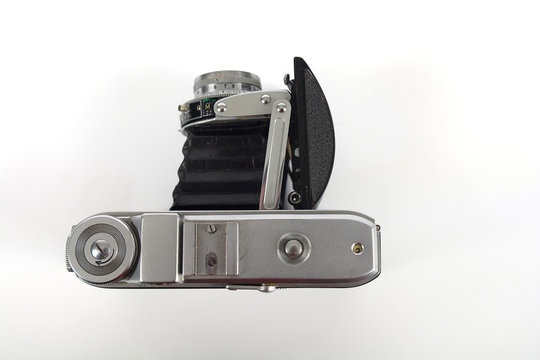 Antique film camera on a white background with pop out lens