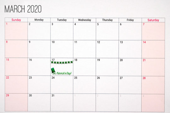 March 2020 calendar with st. patricks day written on tuesday the 17th. Decorated with green hat and green clover decoration. .Celebration and anniversary concept.