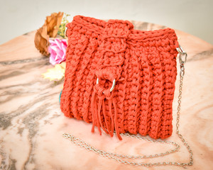 Fototapeta na wymiar Handmade Red Clutch Crochet Bag
