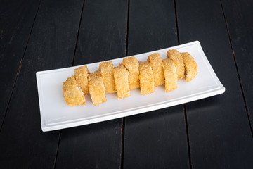 Sushi on the plate on the black table