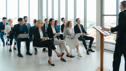 business background of business people having attention and listening to speaker in business seminar