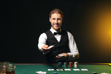 Young male banker at table in casino
