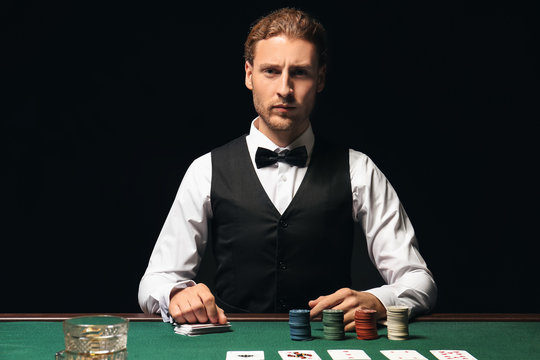 Young male banker at table in casino