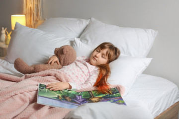 Cute little girl sleeping in bed