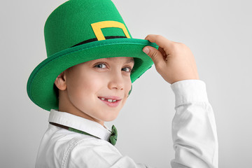 Funny little boy on white background. St. Patrick's Day celebration