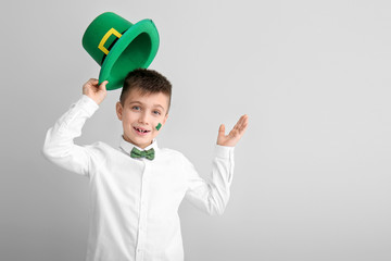 Funny little boy on white background. St. Patrick's Day celebration