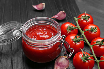 Fototapeta na wymiar Jar with tasty tomato sauce on table, closeup