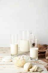 Different dairy products on white wooden table