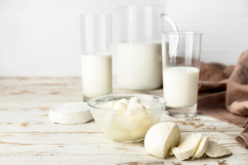 Different dairy products on white wooden table