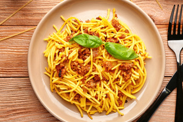 Plate with tasty pasta bolognese on table
