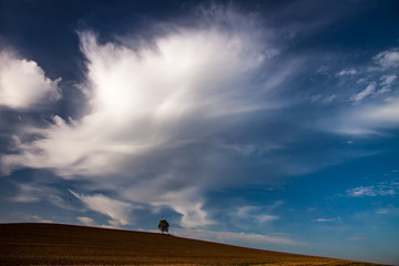 dramatic clouds over the hill