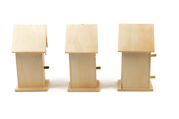a row of small wooden bird houses isolated on white
