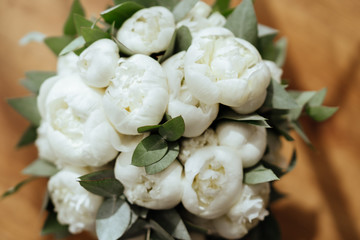 Close-up image of a beautiful and stylish wedding bouquet of white and pink peonies. Summer floral composition.