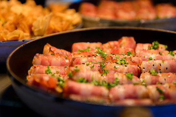 Prawn wrapped with bacon and rosemary. baked appetizer. Close-up shot.