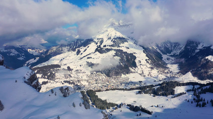 Fototapeta premium The Swiss Alps in winter - flight over wonderful snow mountains - aerial photography