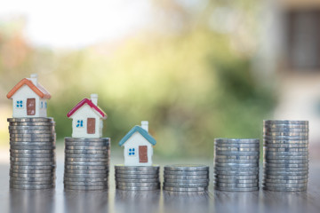 Business Startup. mortgage and real estate investment. mini house on coin stack