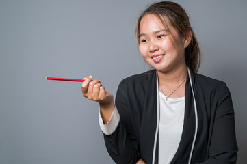 Portrait of wonderful young business woman on gray background with copy space