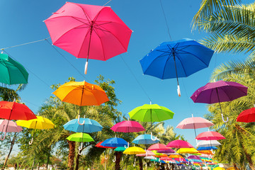 Fototapeta na wymiar Colorful umbrellas in the sky in street decoration