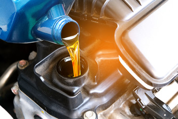 Refueling and pouring oil quality into the engine motor car Transmission and Maintenance Gear...