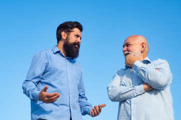 Handsome senior men in blue shirt. Male multi generation family walking. Happy grandfather and father over blue sky and clouds background. Male multi generation family.