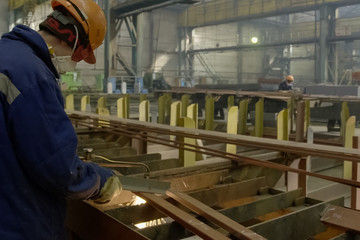 The welder cuts the metal with gas welding.