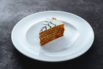 carrot cake with walnuts, prunes and dried apricots on a dark background.