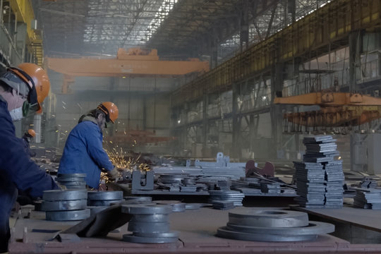 Workers grind the details at the shipyard.