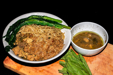 Indonesian traditional chicken noodles with black background.