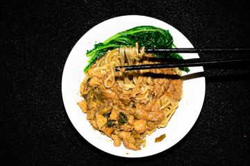 Indonesian traditional chicken noodles with black background.