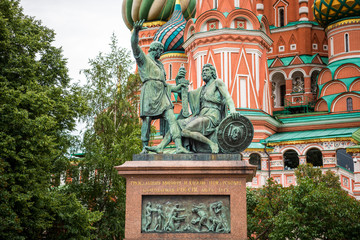 Fototapeta na wymiar Monument to Minin and Pozharsky, a bronze statue on Red Square in Moscow, Russia, in front of Cathedral of Vasily the Blessed, or Saint Basil's Cathedral, regarded as a symbol of the country.
