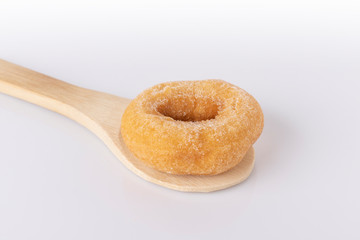 Donuts on a wooden spoon on a white background.