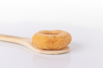 Donuts on a wooden spoon on a white background.