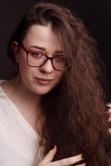 portrait of a plump brunette with long curly hair