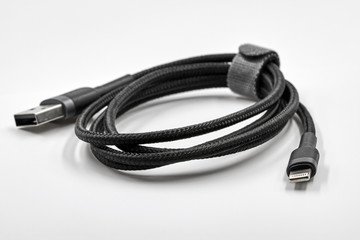 Black adapter USB to micro USB type c data and power cable on white background. Closeup