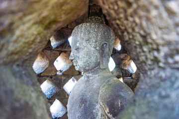 A close up Buddha statue inside a stupa in Borobudur Temple, Magelang, Central Java, Indonesia. Borobudur Temple will be the location to celebrate Vesak Day in Indonesia.