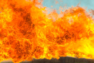Flame tongues from the flamethrower. background of fire
